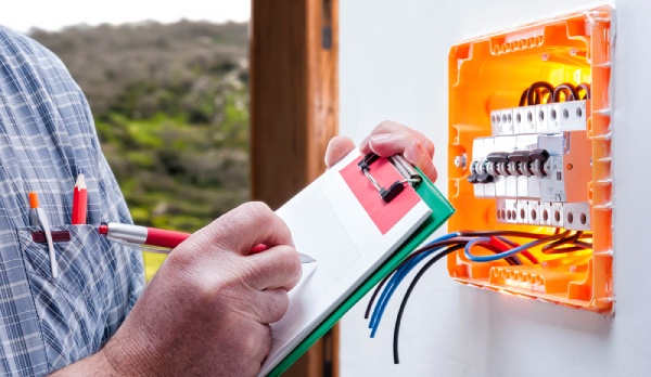 A technician inspecting an electrical panel
