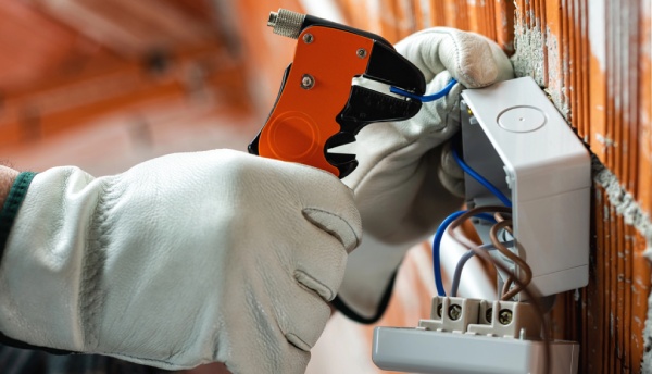 An electrician holding a wire striper