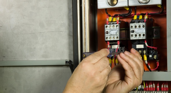 An expert checking an electrical panel