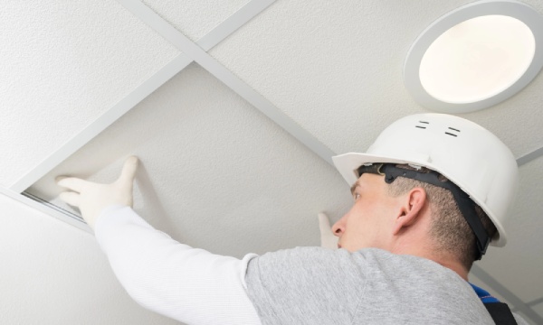 An expert checking the ceiling support