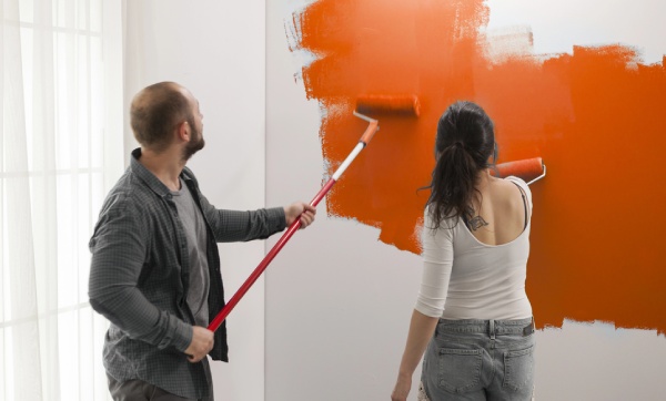 A couple painting a room