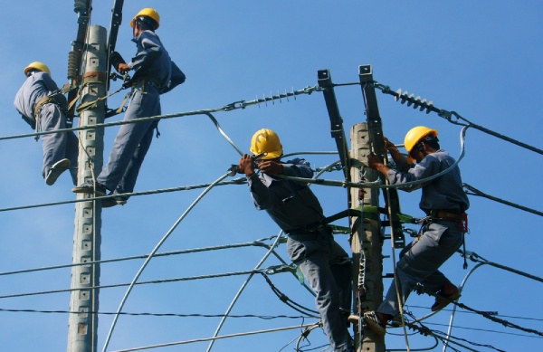 A group of electricians working on street cable