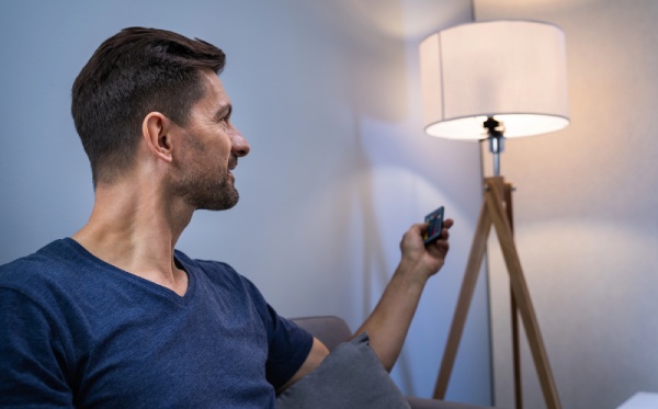 A man controlling a smart light