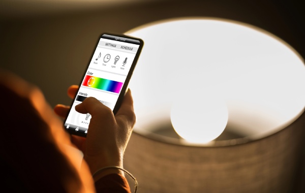 A person controlling smart lights using a mobile app