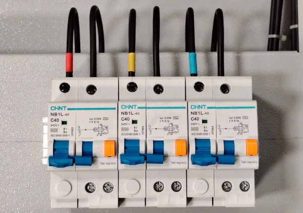 A row of installed residual current circuit breakers with overload protection