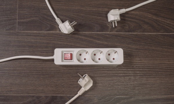 Three electrical plugs on the floor