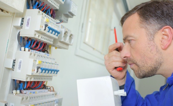 An electrician during electrical inspection