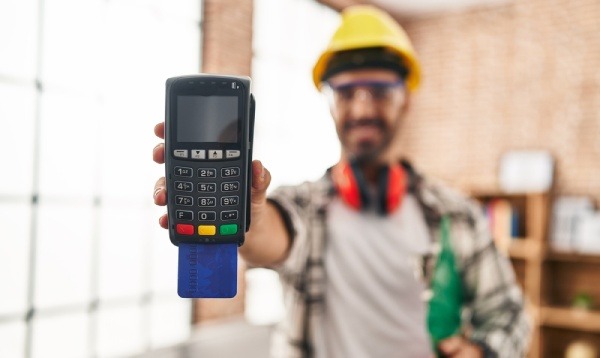 A worker holding an EDC machine