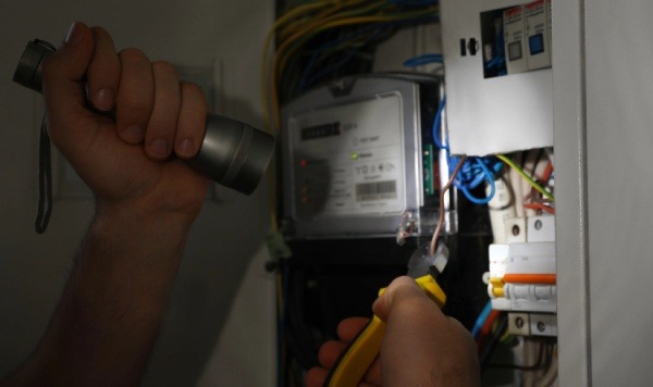 An electrician fixing a panel